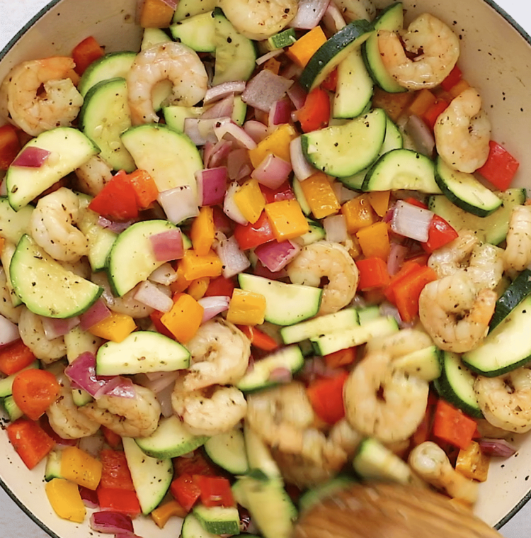overhead view of shrimp and veggies in a skillet