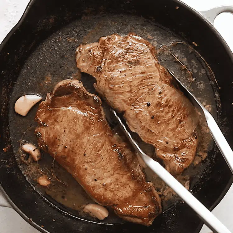 overhead view of steak in a cast iron skillet