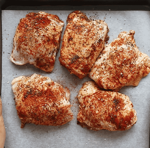 overhead view of Chicken thighs in a baking sheet