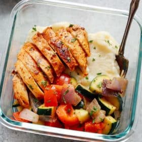 close up of a glass meal prep bowl containing low carb chicken meal prep bowls