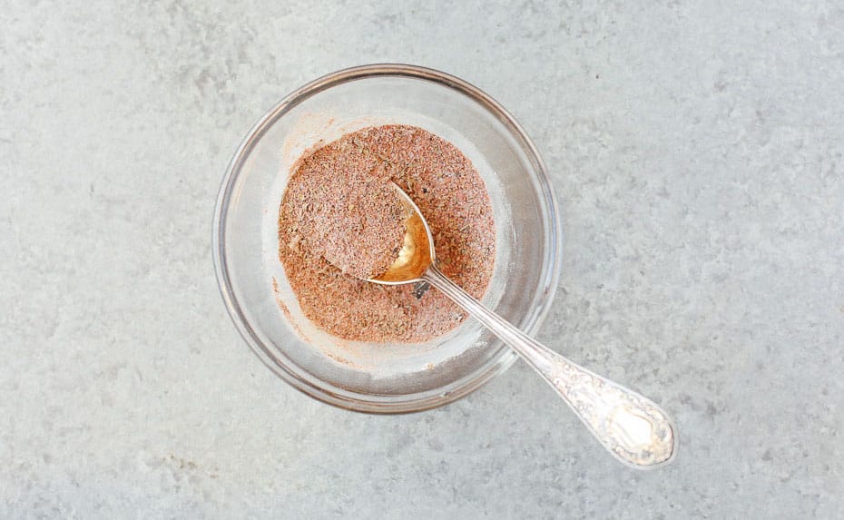 Bowl of seasoning with a spoon.