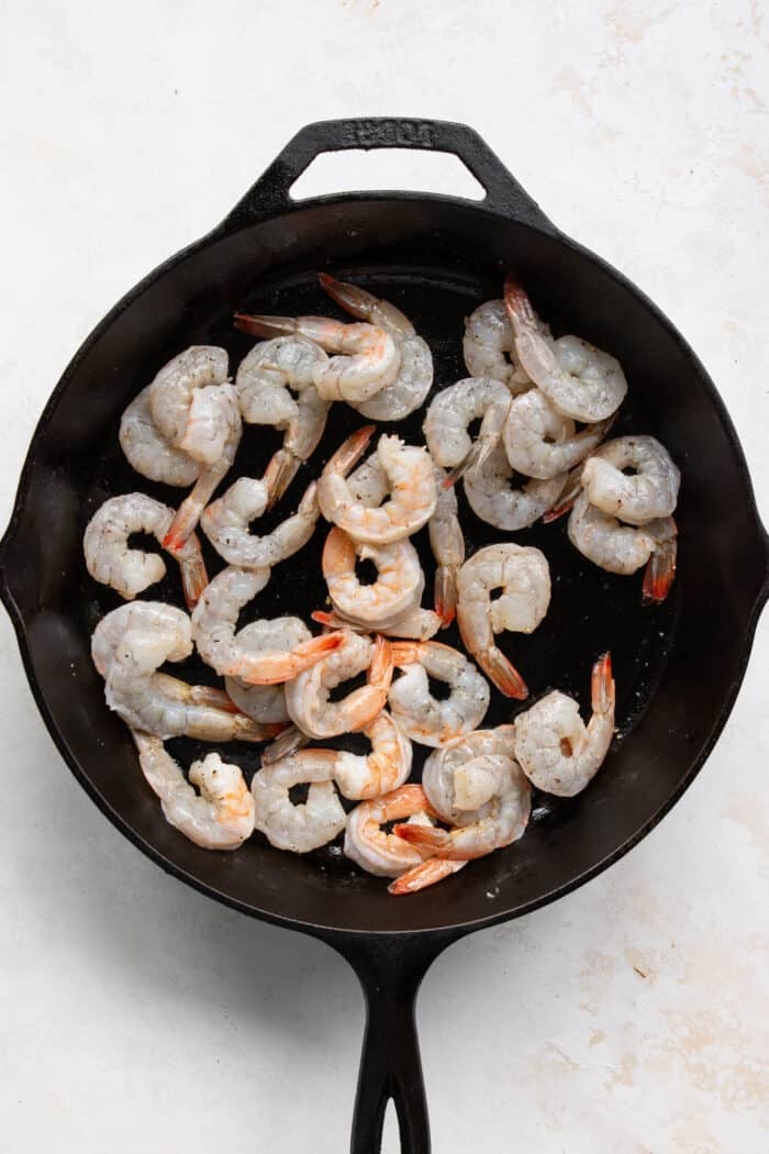 raw shrimp in a cast iron skillet