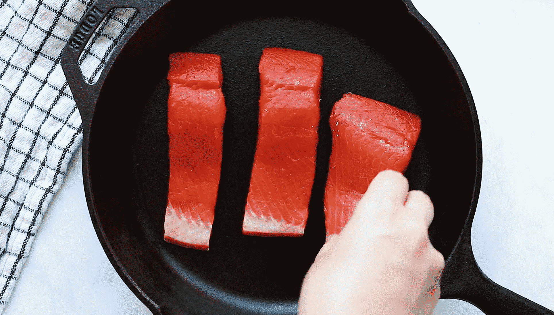 overhead view of a cast iron skillet containing salmon