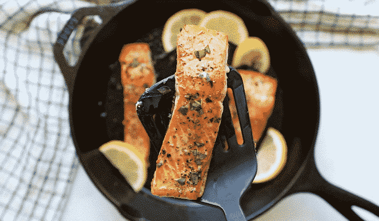 overhead view of a cast iron skillet containing salmon