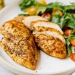 closeup of 2 air fryer chicken breast on a white plate