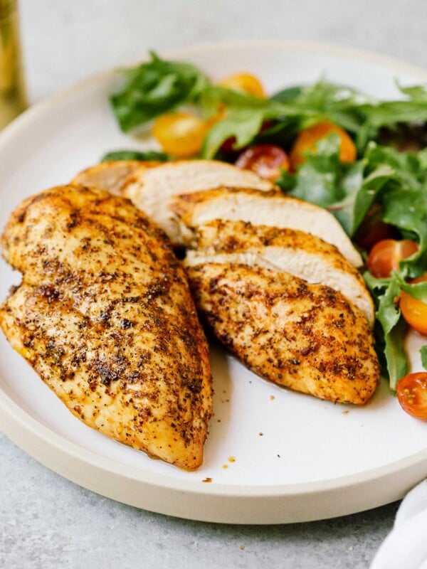 closeup of 2 air fryer chicken breast on a white plate