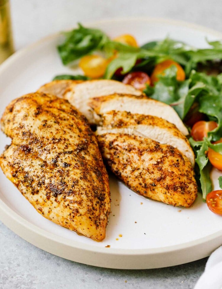 closeup of 2 air fryer chicken breast on a white plate