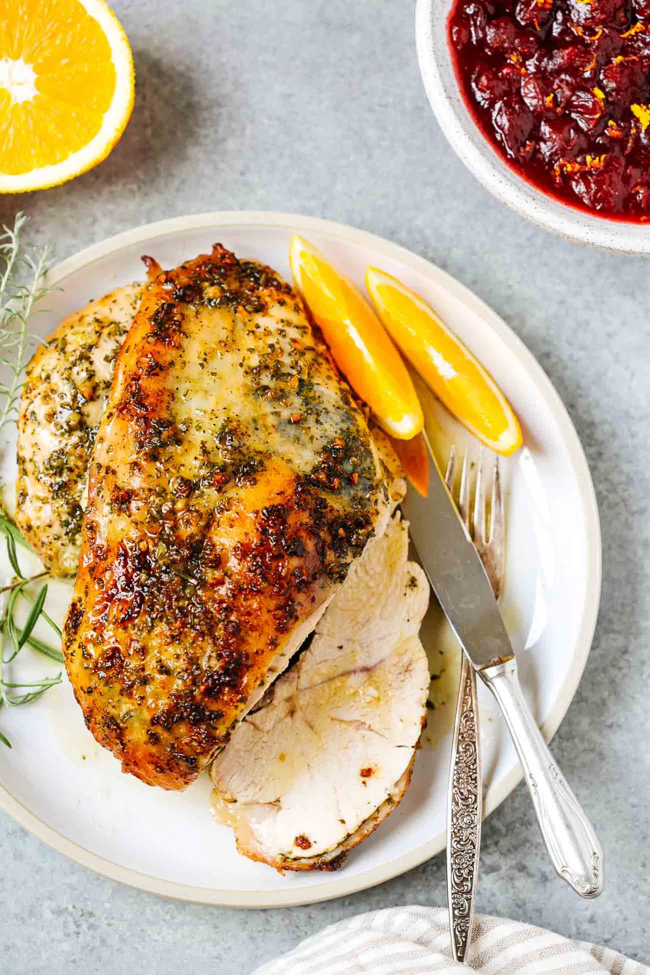 Overhead view of a garlic butter turkey breast cut on a plate.