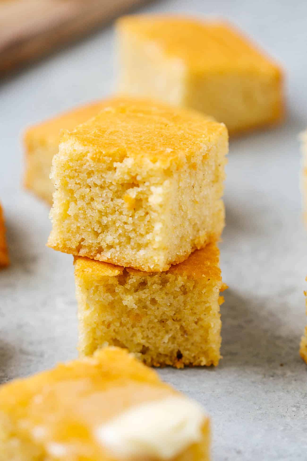 Two pieces of gluten free cornbread stacked on top of each other.