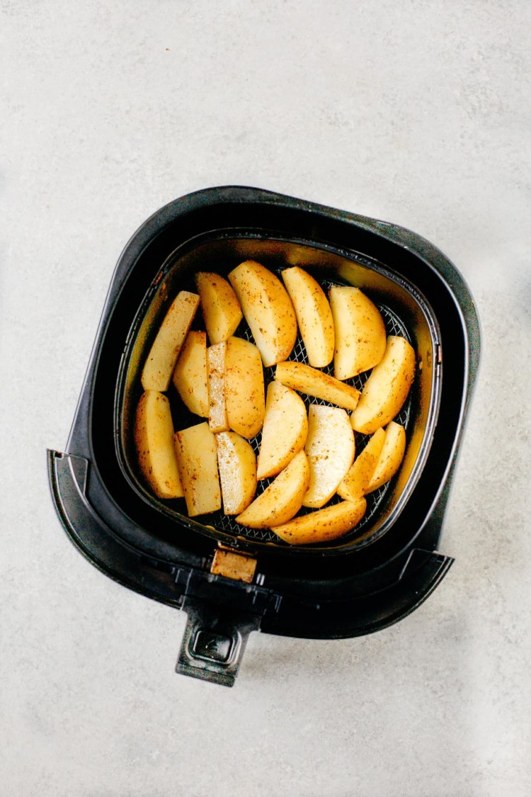 potato wedges in an air fryer pan