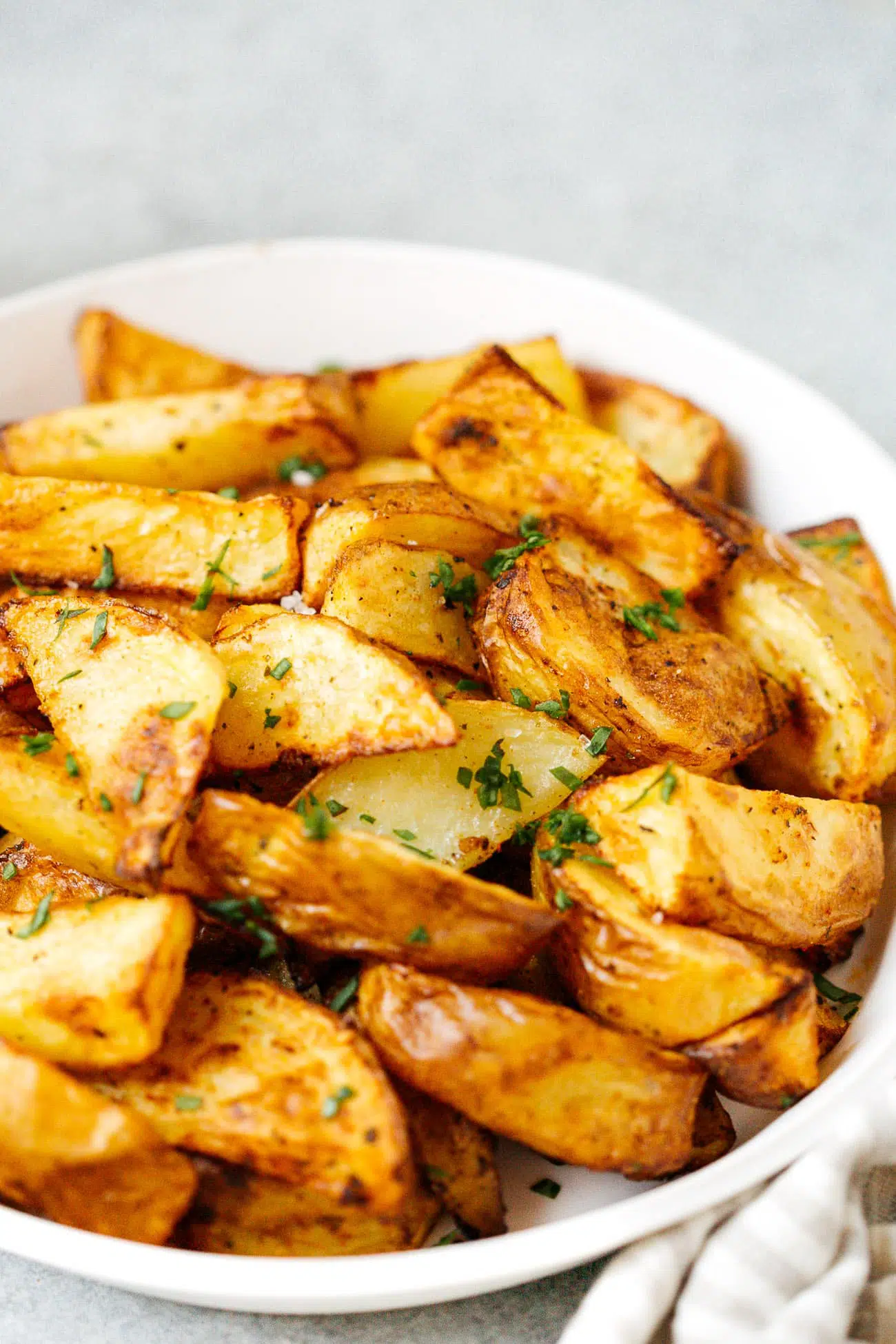 Close up of a plate of potato wedges.