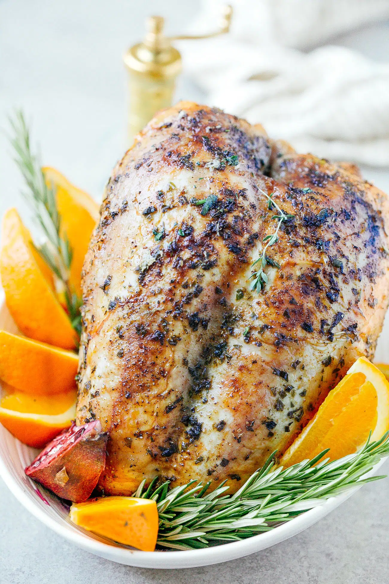 A easy roasted turkey breast with fresh citrus and herbs around it.