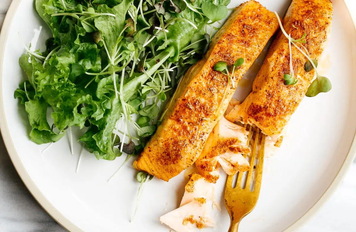 overhead view of white plate containing air fryer salmon