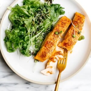 overhead view of white plate containing air fryer salmon