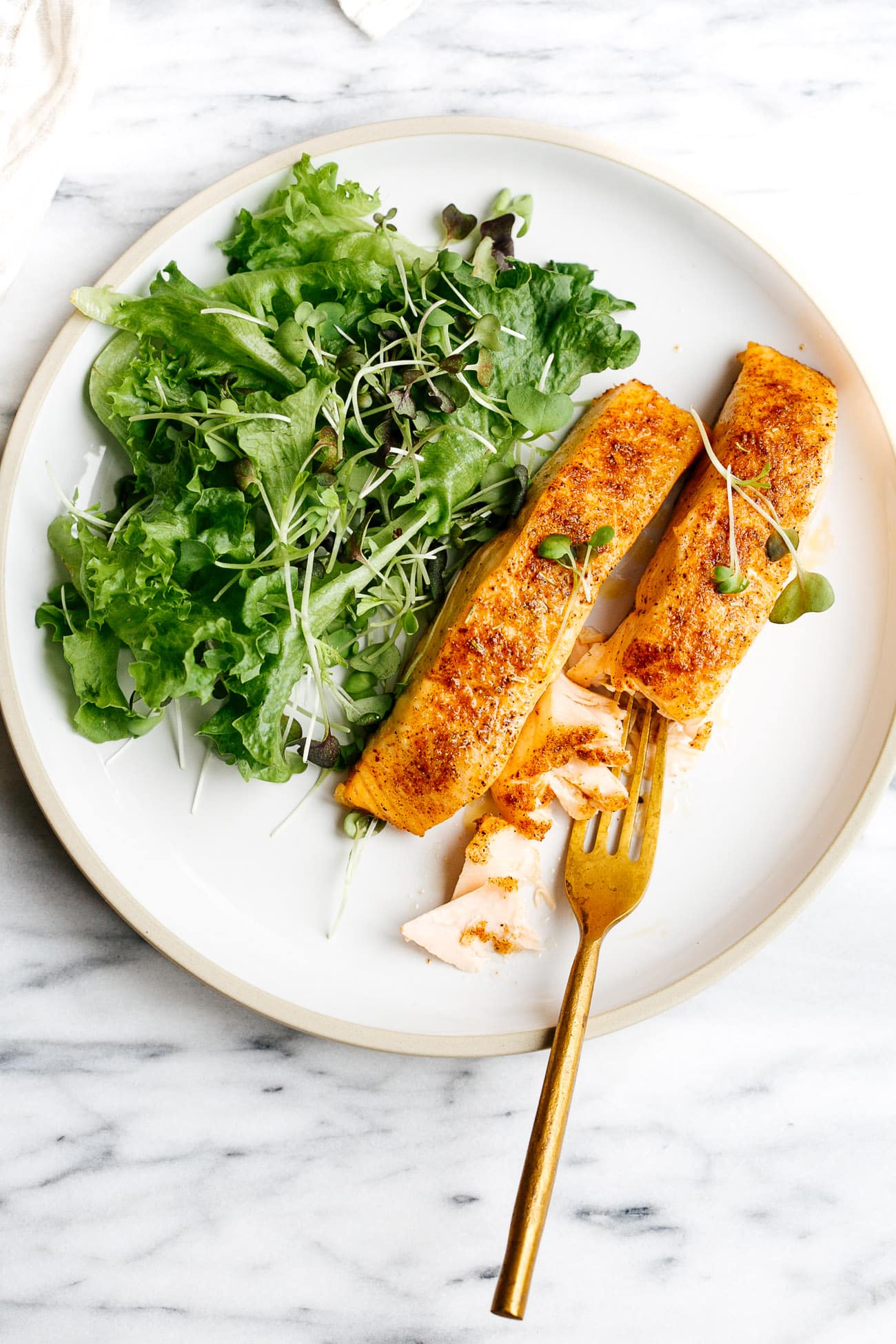 overhead view of white plate containing air fryer salmon