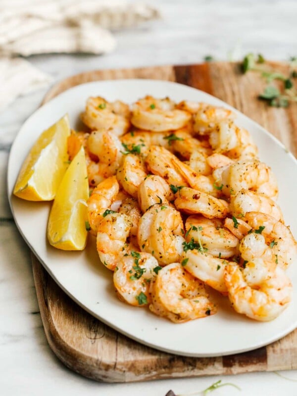 overhead view of a white plate containing cooked shrimp