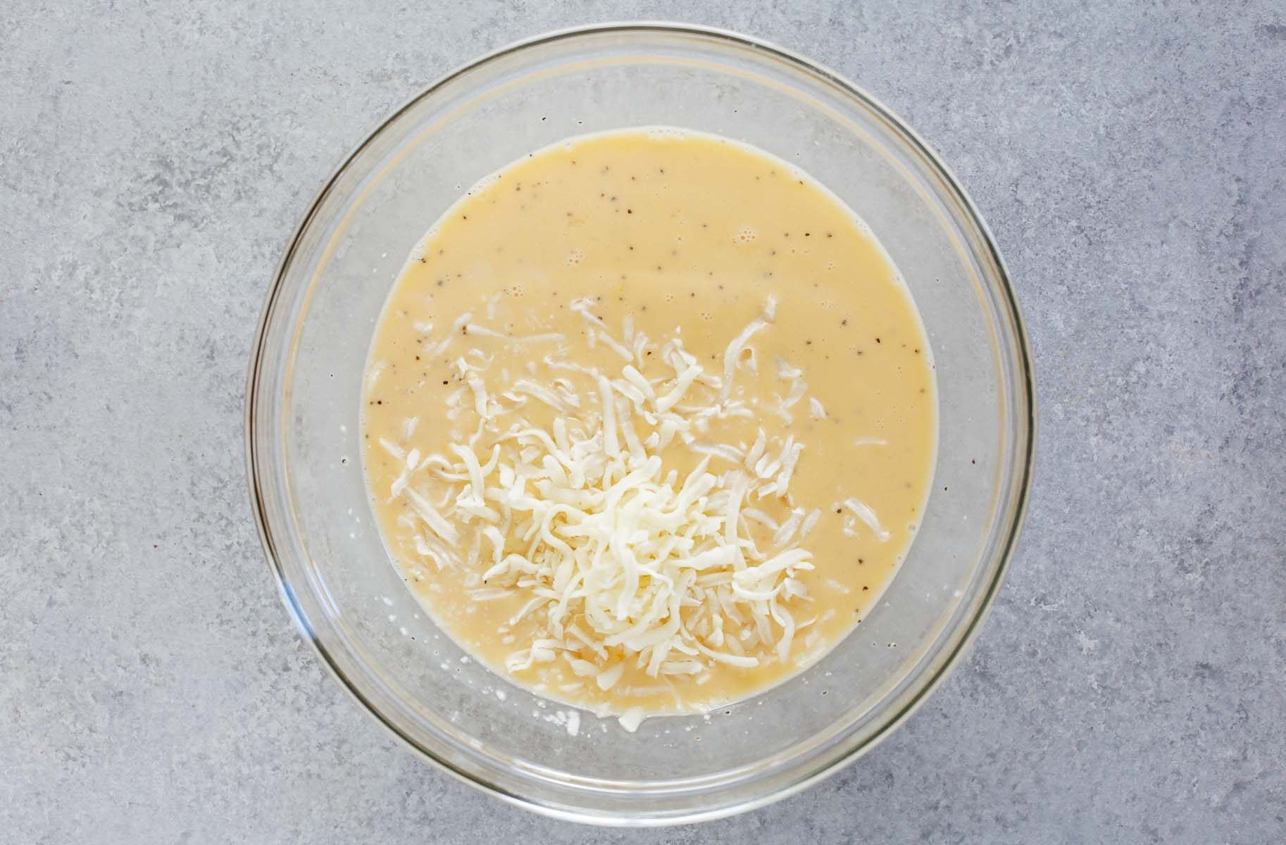 eggs and cheese in a glass bowl.