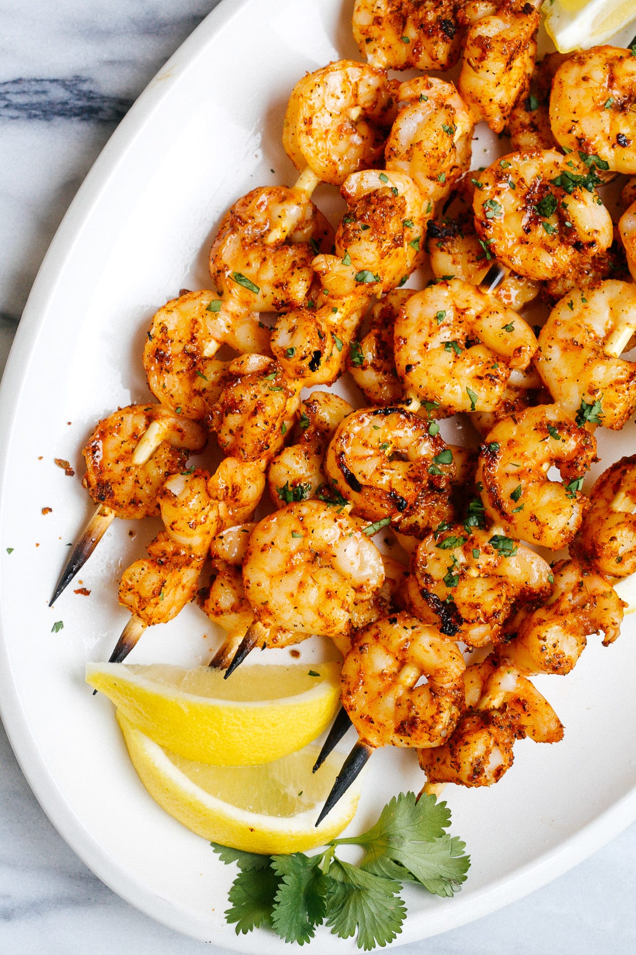 shrimp kabobs on a white plate