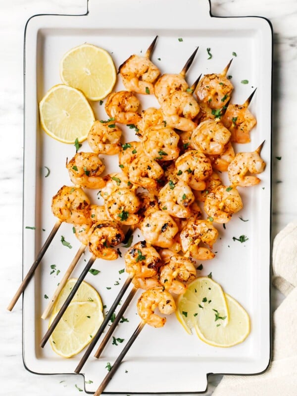 overhead of grilled shrimp on a white plater