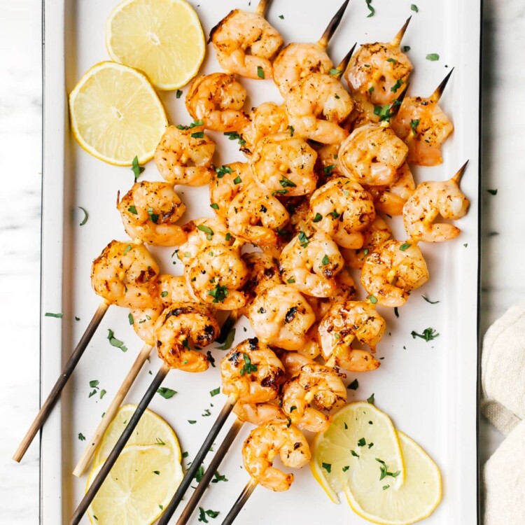 overhead of grilled shrimp on a white plater