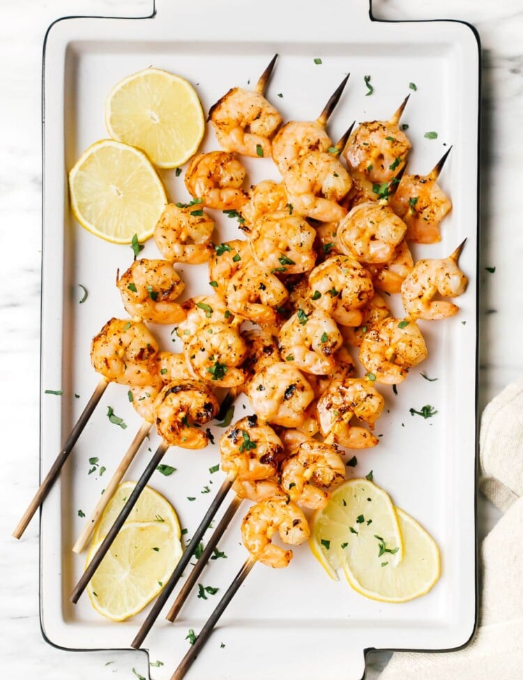 overhead of grilled shrimp on a white plater