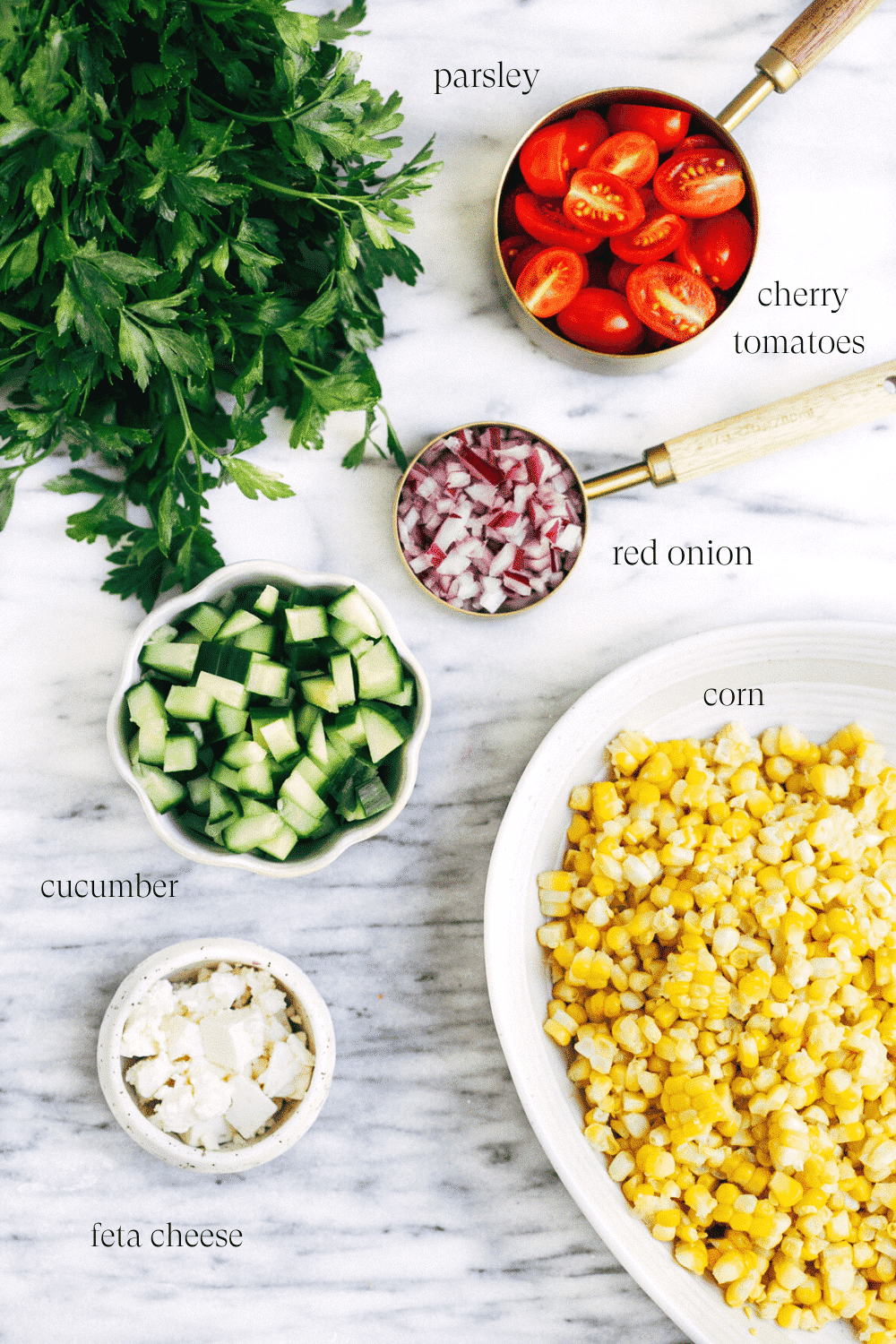 ingredients to make a corn salad on a marble board