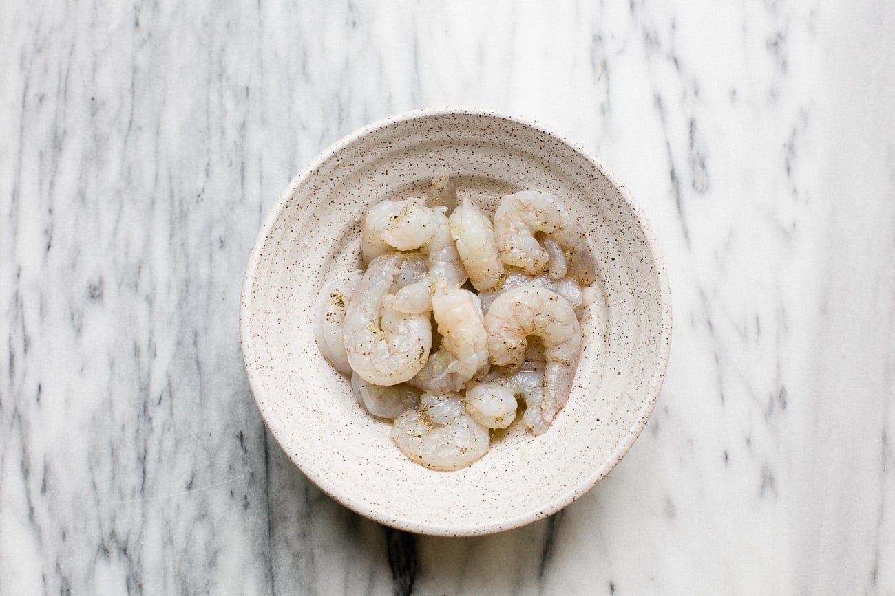 overhead view of raw shrimp in a white house