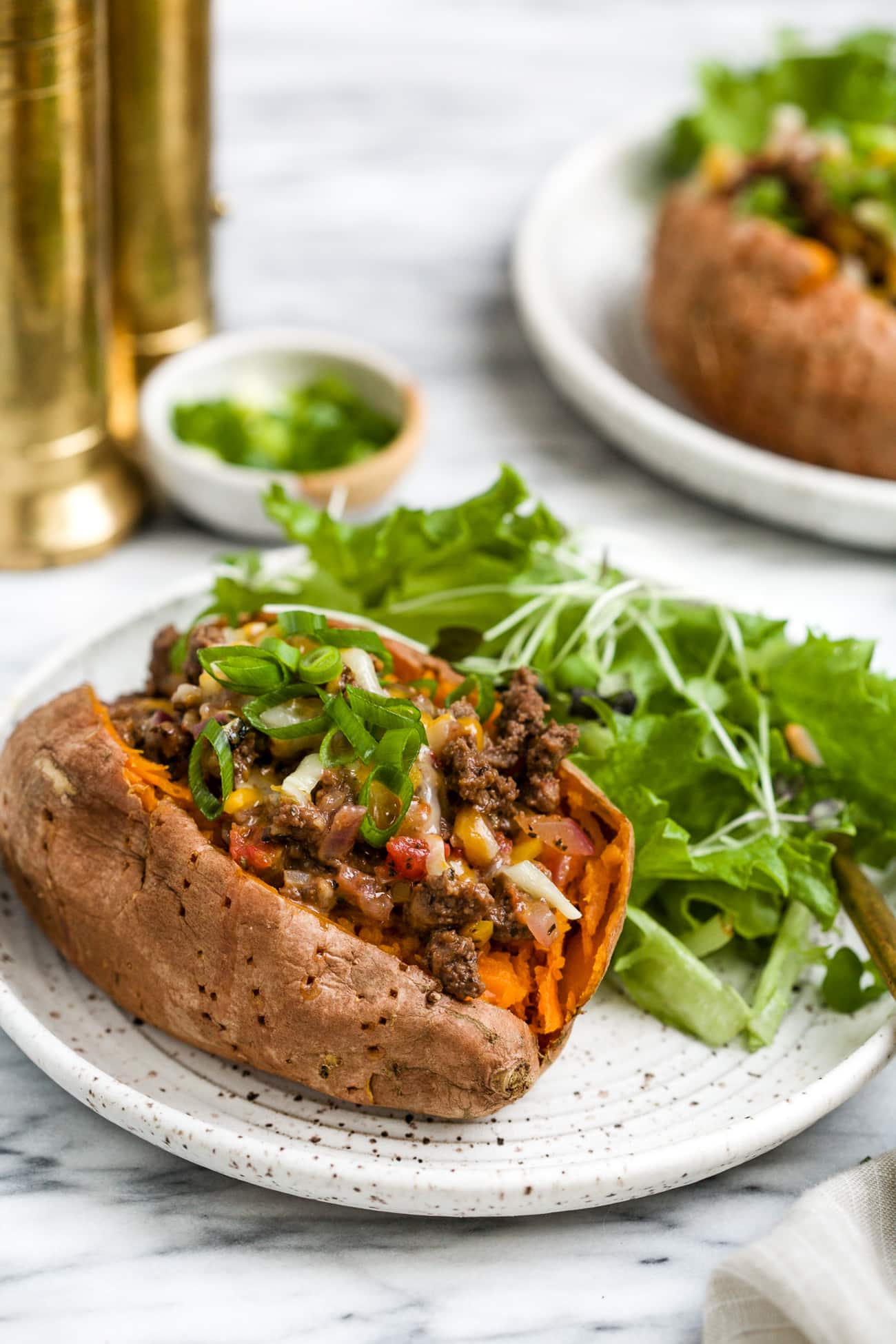 closeup view of stuffed sweet potato on a white plate.