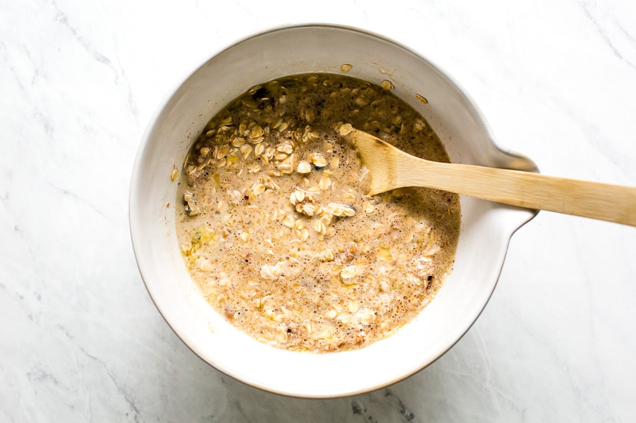 Wet and dry ingredients combined in a large bowl to form baked oatmeal batter.