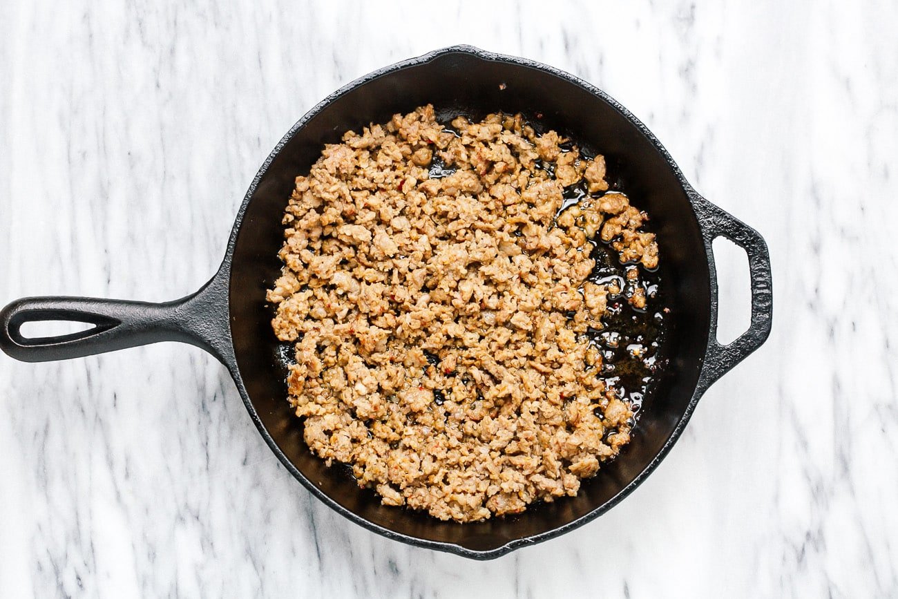 Browned sausage in a cast iron skillet.