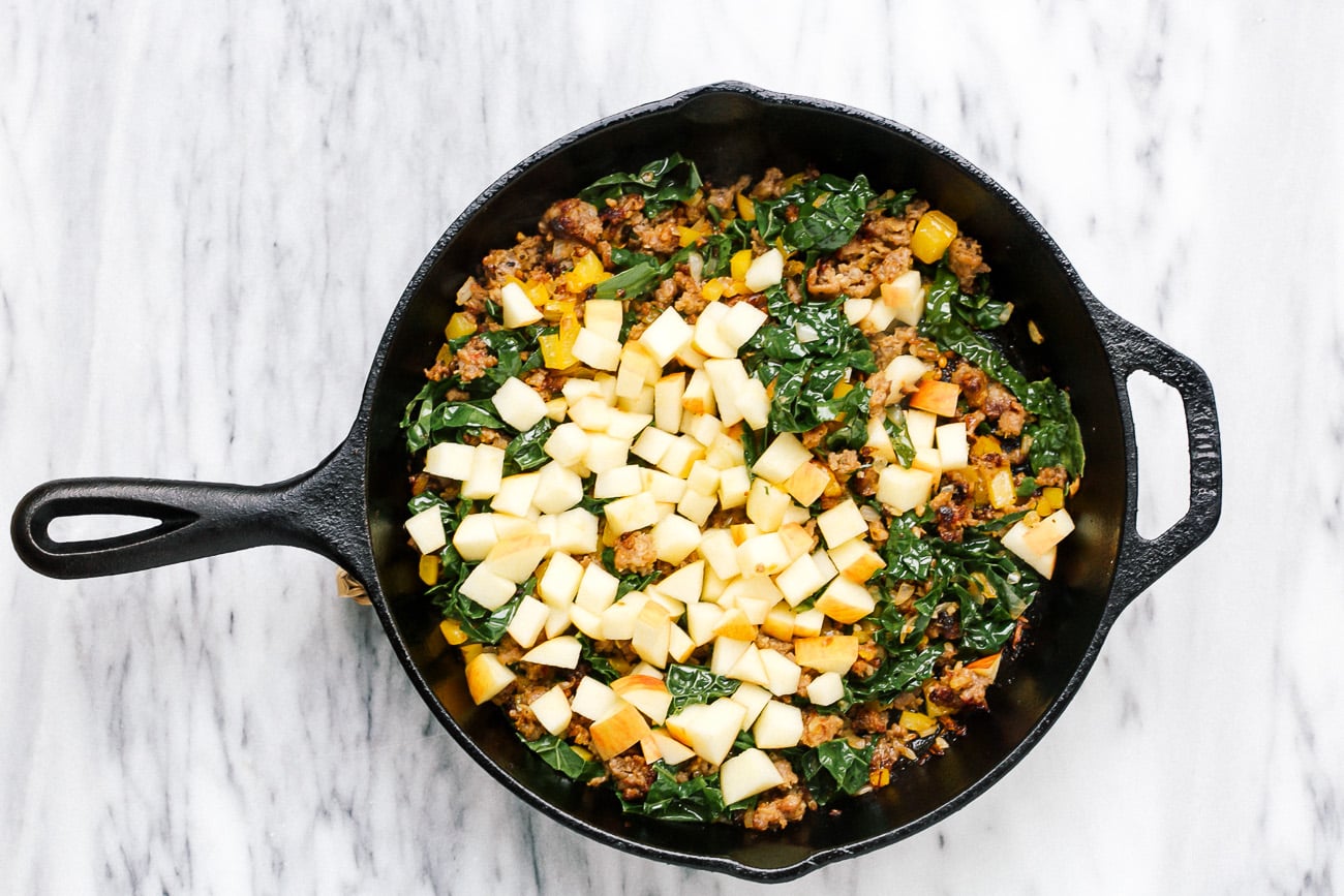 Kale, diced apple and sage added to skillet with browned meat and veggies.