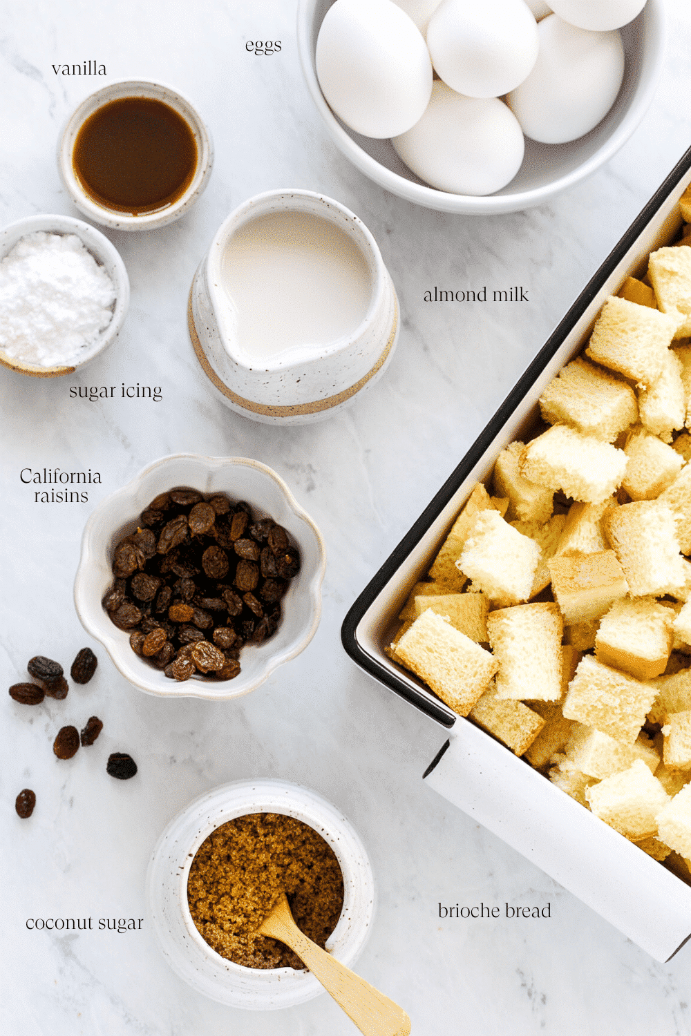 Ingredients for French toast casserole arranged on a white countertop. 