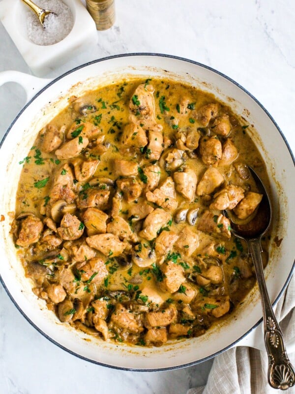 overhead view of chicken stroganoff in a braiser white pan.