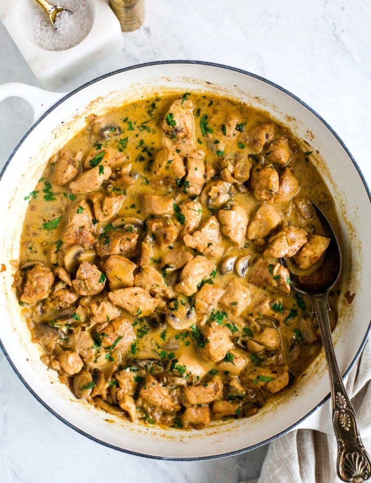 overhead view of chicken stroganoff in a braiser white pan.