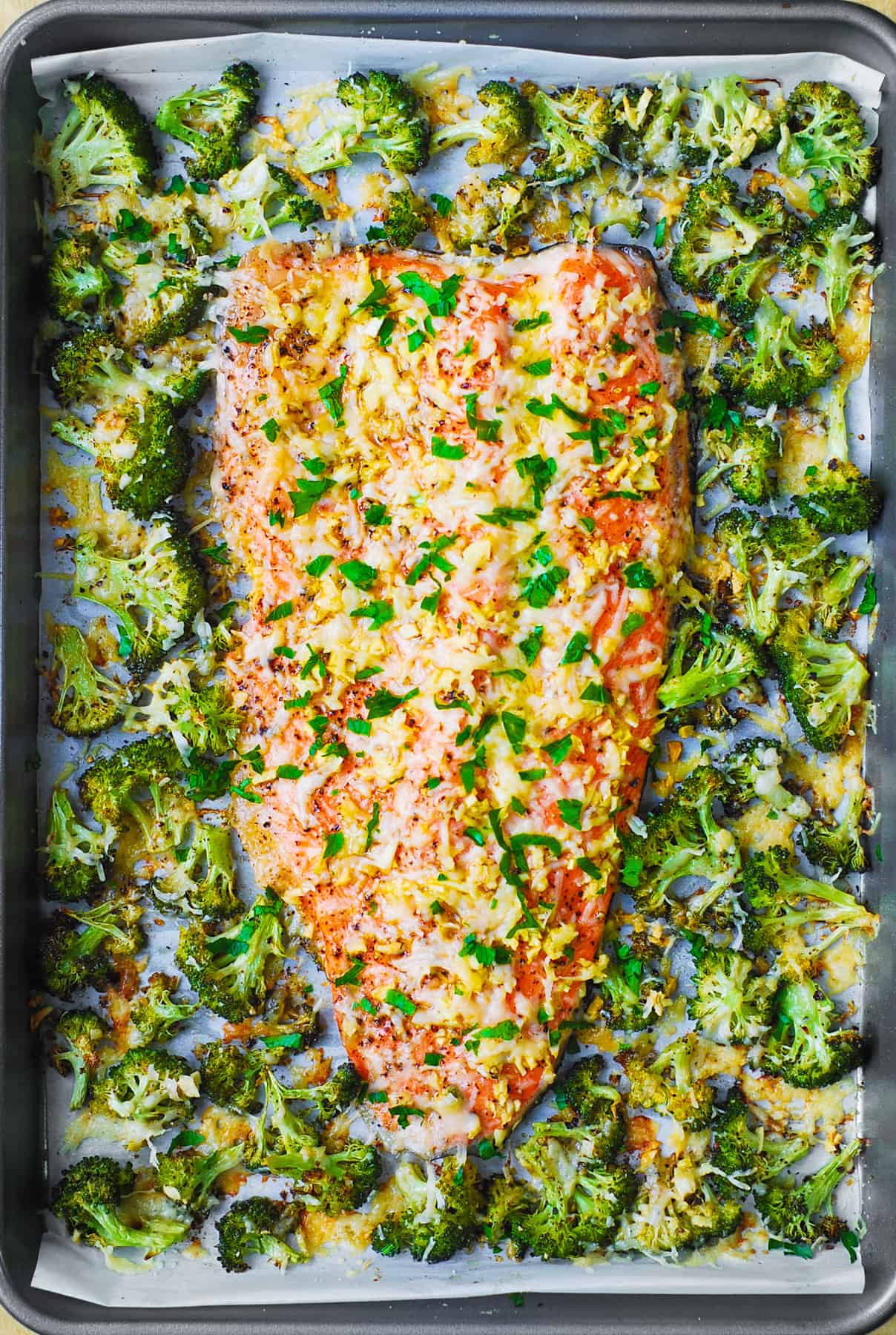 Sheet pan salmon with broccoli, golden roasted florets and flaky salmon fillets
