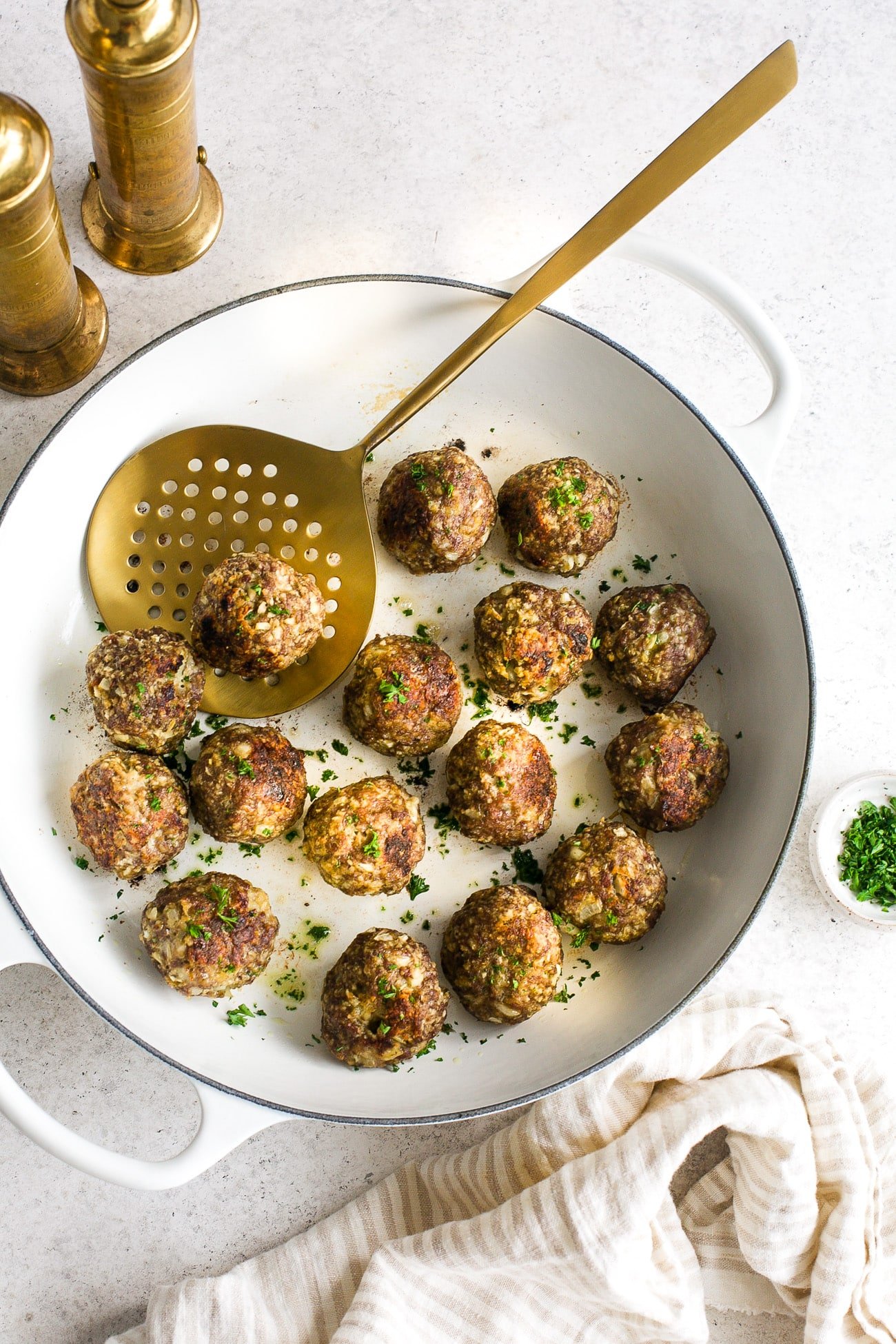 Overhead view of turkey Meatball in a white skillet