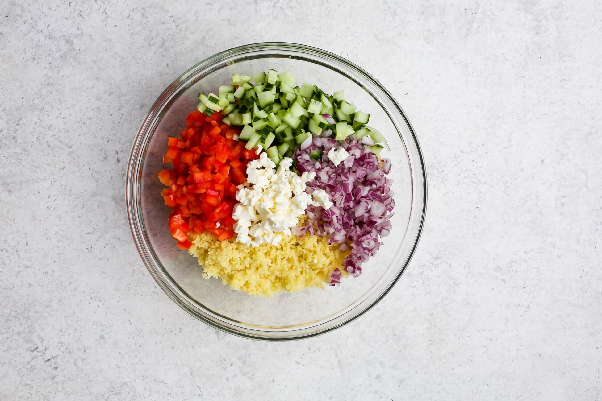Salad ingredients measured into a large bowl.