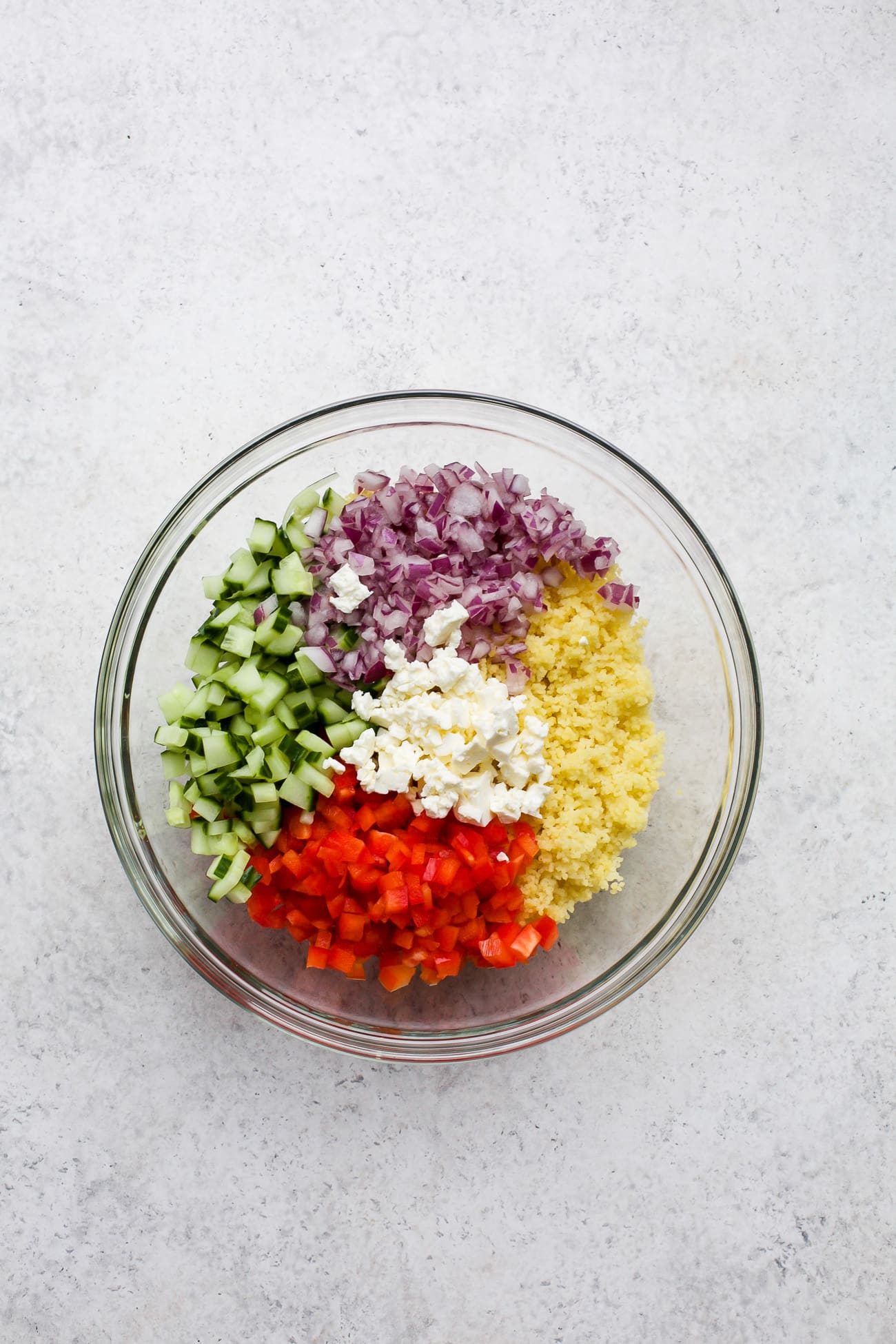 Salad ingredients measured into a large bowl.
