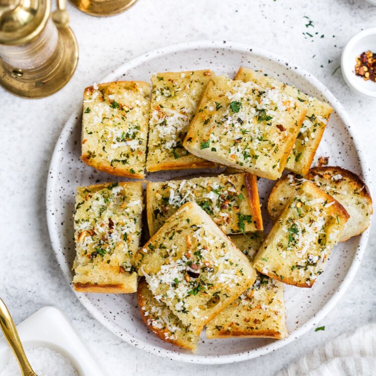 overhead view of garlic bread on a white plate