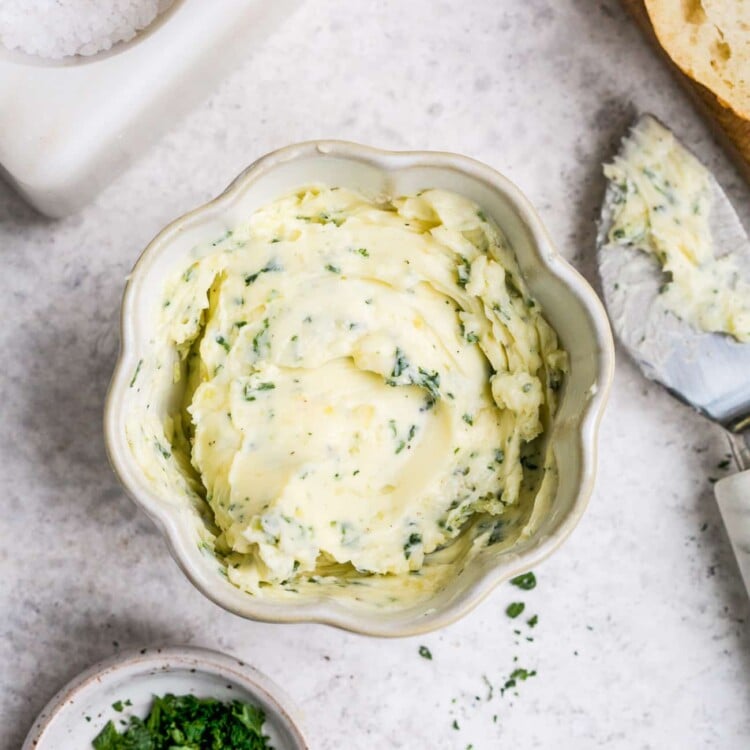 overhead view of garlic butter in a small white bowl