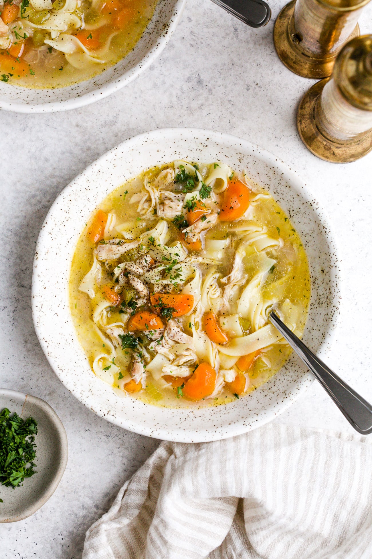 Instant pot chicken noodle soup in a white serving bowl. 