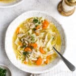 Instant pot chicken noodle soup in a white serving bowl.