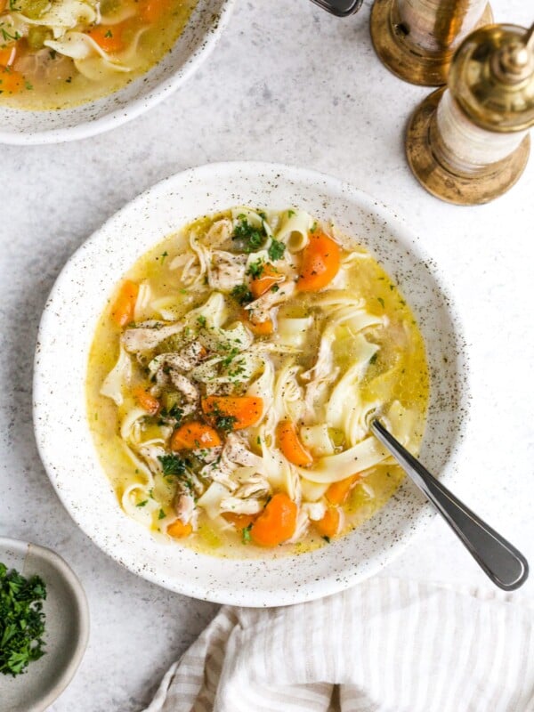 Instant pot chicken noodle soup in a white serving bowl.