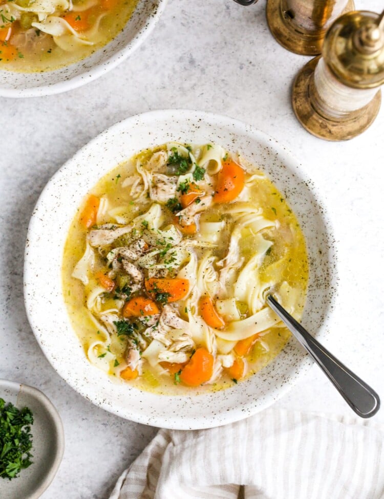 Instant pot chicken noodle soup in a white serving bowl.