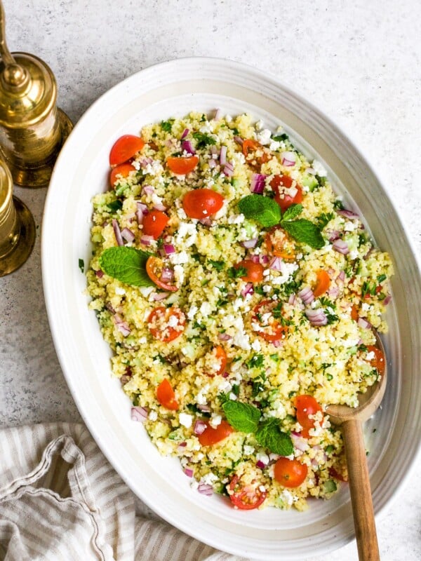 closeup of couscous salad in a white bowl.