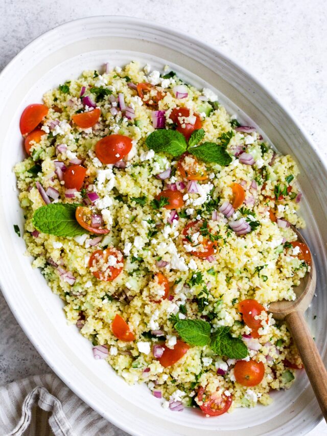 closeup of couscous salad in a white bowl.