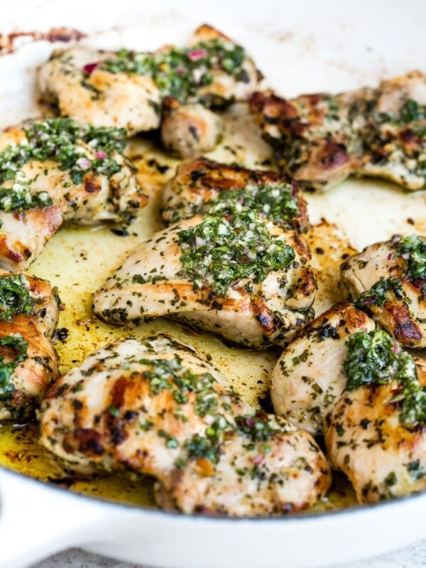 Chimichurri chicken in a large, white skillet.