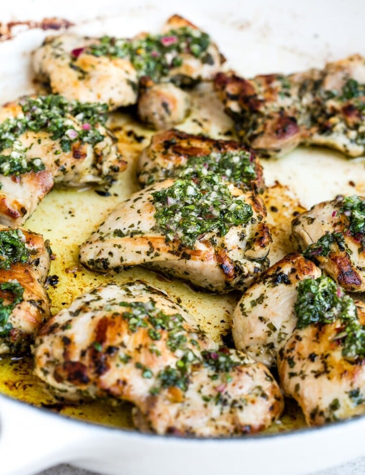 Chimichurri chicken in a large, white skillet.