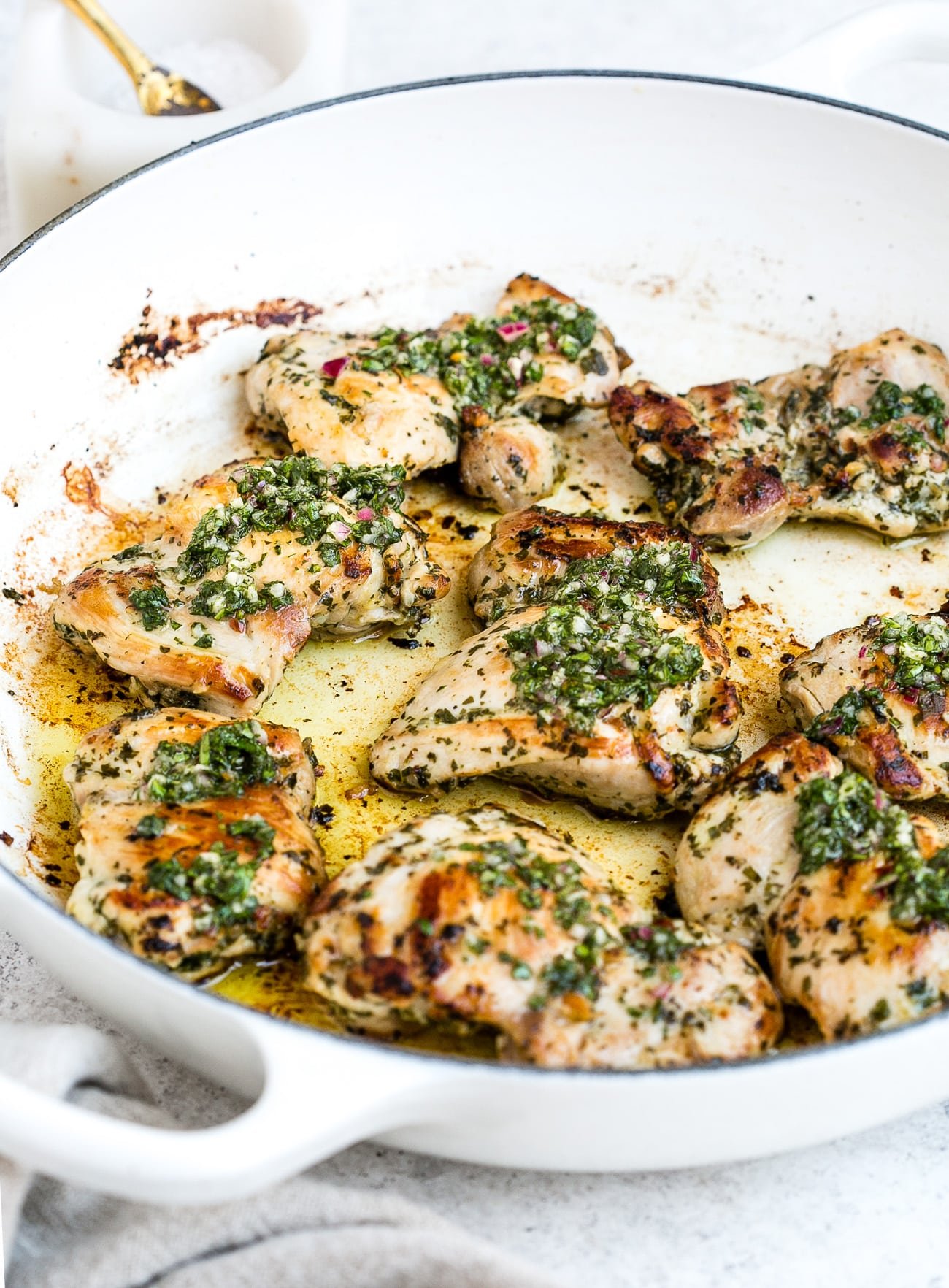 Chimichurri chicken in a large, white skillet.