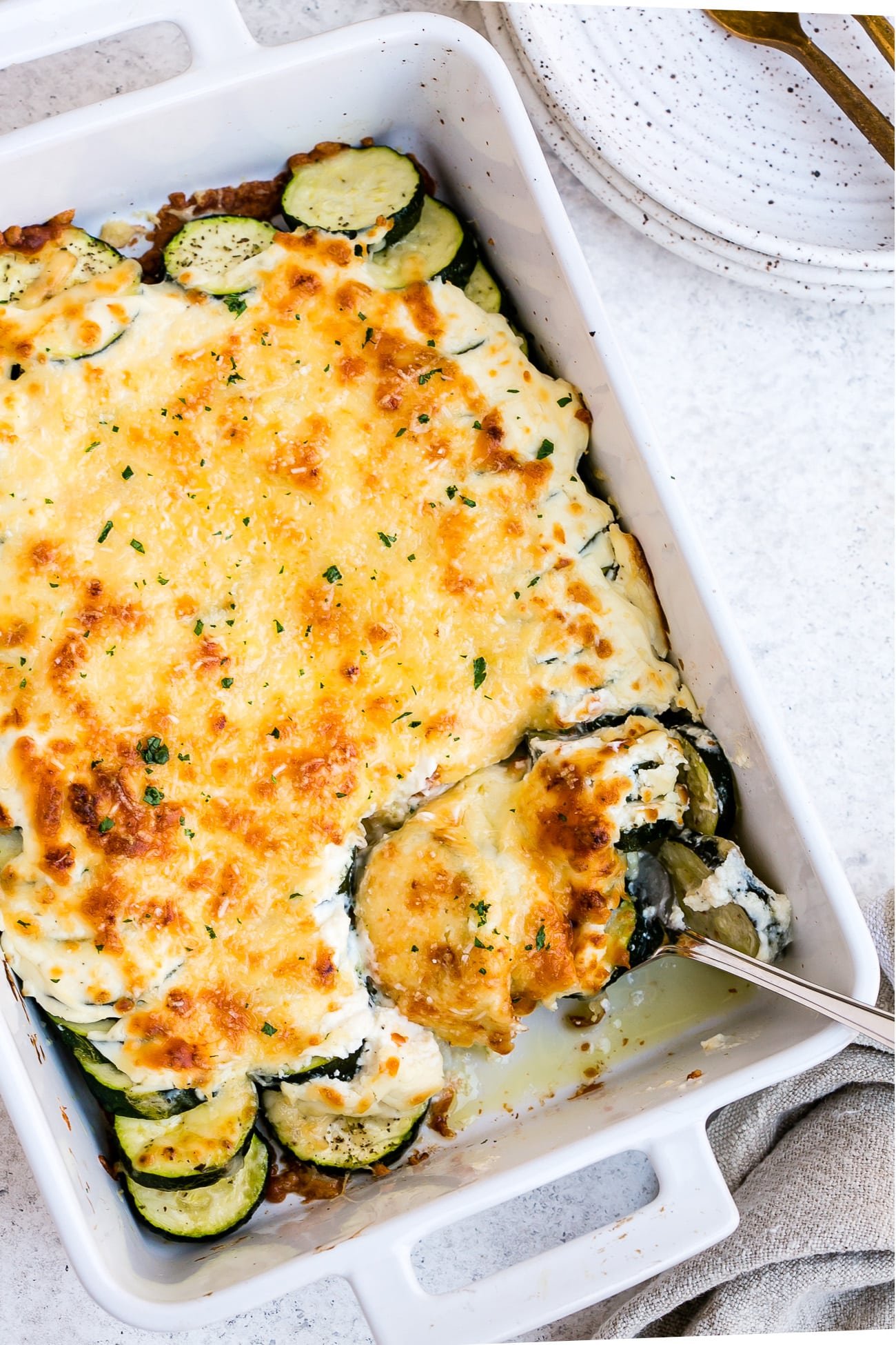 Zucchini casserole in a large, white baking dish.